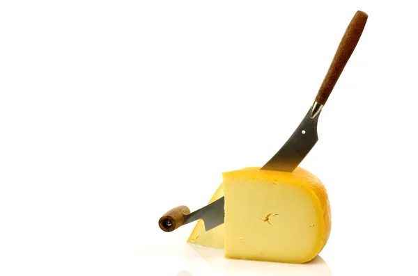 Traditional Gouda cheese pieces with a cheese cutter — Stock Photo, Image