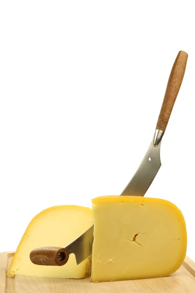 Traditional Gouda cheese pieces with a cheese cutter — Stock Photo, Image