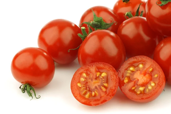 Fresh cherry tomatoes on the vine with one cut — Stock Photo, Image