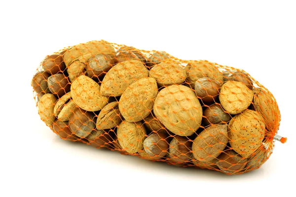 Verschiedene Nüsse in einem orangefarbenen Kunststoff — Stockfoto