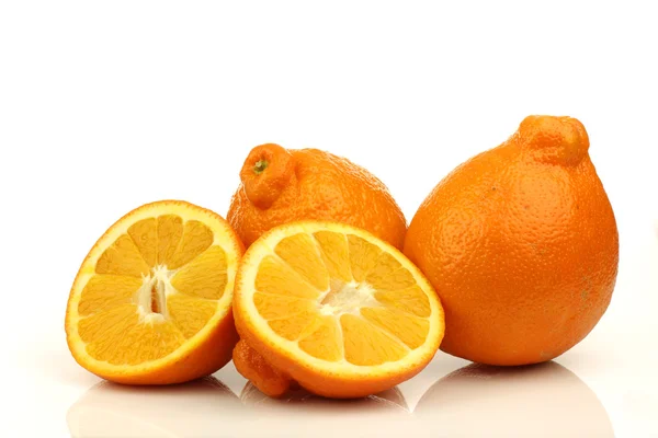Two fresh minneola's and a cut one — Stock Photo, Image