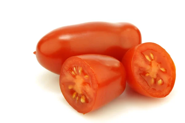 One whole italian tomato and two halves — Stock Photo, Image