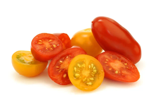 Bunch of mixed red and yellow cherry and italian tomatoes and some halves — Stock Photo, Image