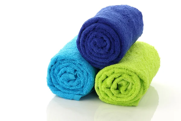 Coloridas toallas de baño enrolladas y apiladas — Foto de Stock