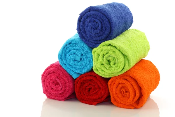 Colorful rolled up and stacked bathroom towels — Stock Photo, Image