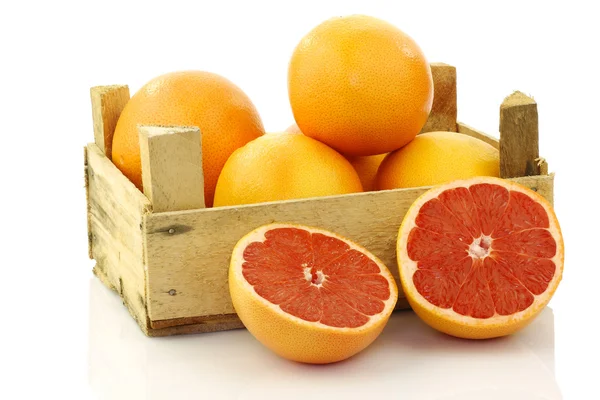 Fresh red grapefruits in a wooden box — Stock Photo, Image