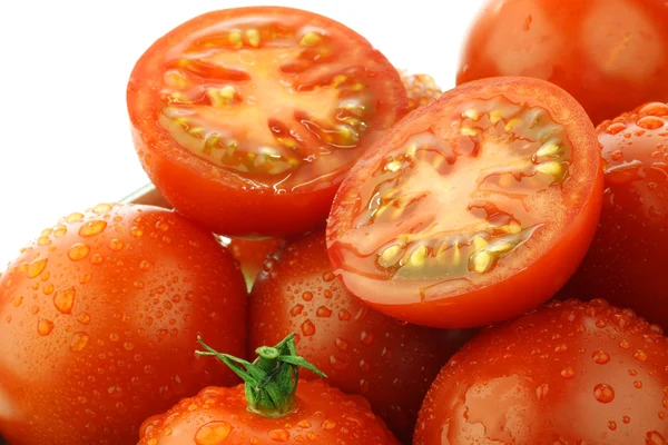 Fresh red tomatoes and two halves with water droplets — Stock Photo, Image
