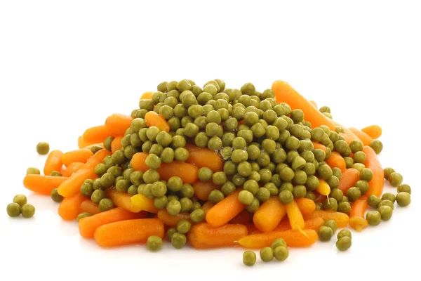Bunch of fresh carrots and green peas — Stock Photo, Image