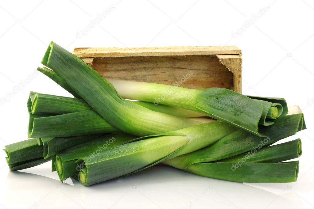 Freshly harvested leek coming from a wooden box