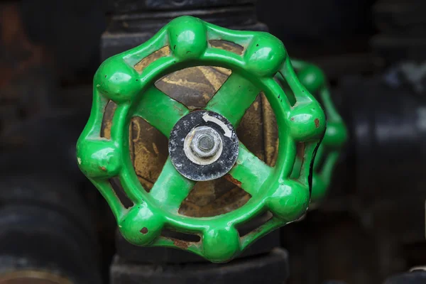 Green rusty industrial faucet wheel — Stock Photo, Image