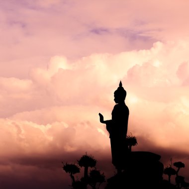 Buddha silhouette on sunset sky. clipart