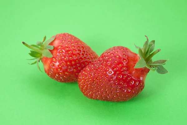 Two Strawberries on green background — Stock Photo, Image