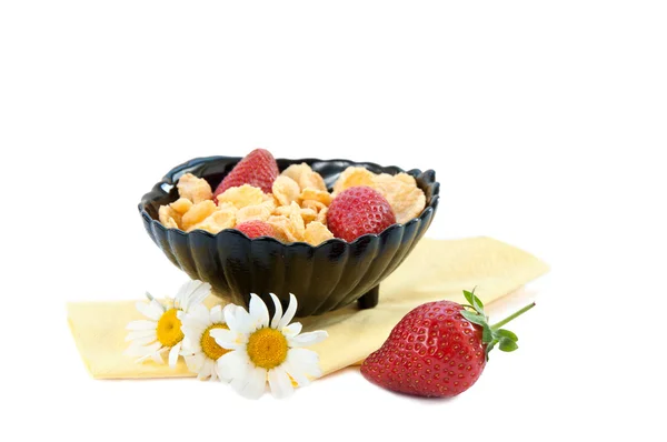 Cornflakes cereal with strawberries in a black bowl — Stock Photo, Image