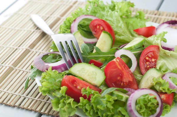 Fresh salad with cucumbers tomatoes and onions — Stock Photo, Image