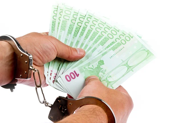 Hand with Euro and handcuffs — Stock Photo, Image
