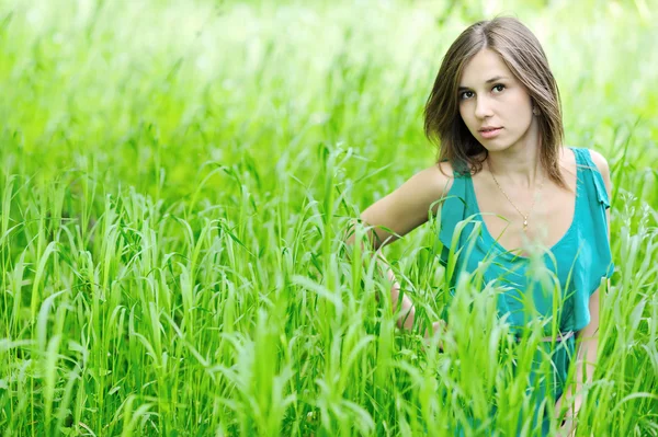 Jovem menina bonita na grama verde — Fotografia de Stock