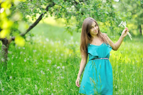 Girl with a dandelions outdoors — Stock Photo, Image