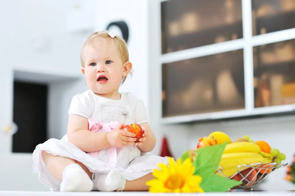 Adorable little girl on a kitchen — Stock Photo, Image