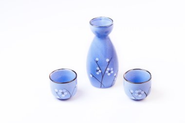 Traditional oriental style Sake set from a jug ahd bowl cups clipart