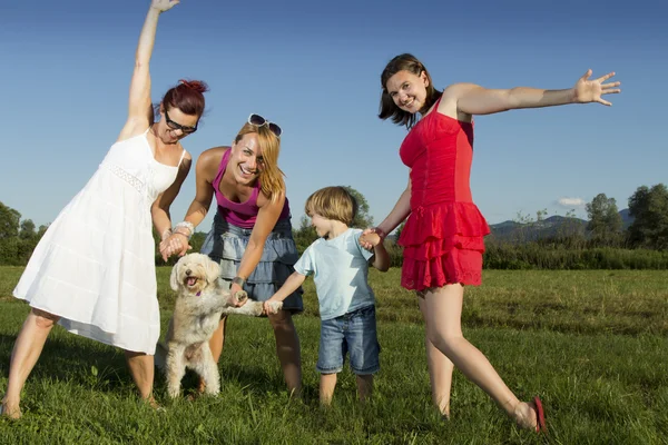 Girlfriends and little boy enjoying sunny summer afternoon outdoors — Stock Photo, Image