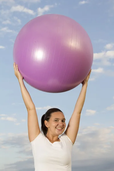 Cute woman working out with a ball — Stock Photo, Image