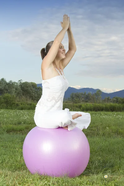Cute woman working out with a ball — Stock Photo, Image
