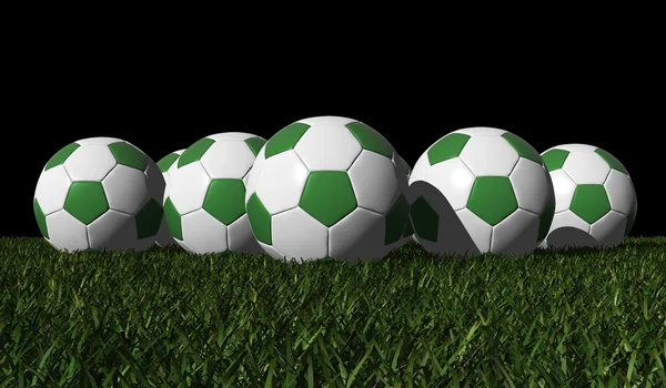 Zelené fotbalové Míče na zelené trávě — Stock fotografie