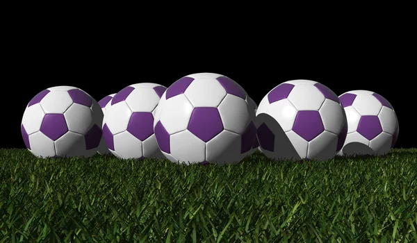 Palloni da calcio viola su un'erba verde — Foto Stock