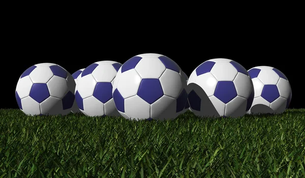 Blue soccer balls on a green grass — Stock Photo, Image