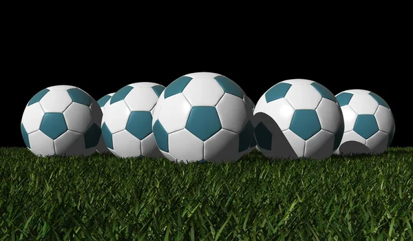 Balles de football cyan sur une herbe verte — Photo