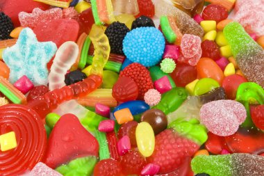 Sweetened assortment of multicolored candies clipart