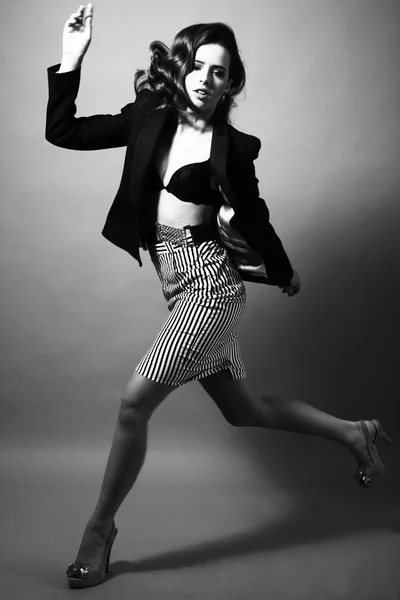 Studio shot of gorgeus model jumping flying in fashion clothes w — Stock Photo, Image
