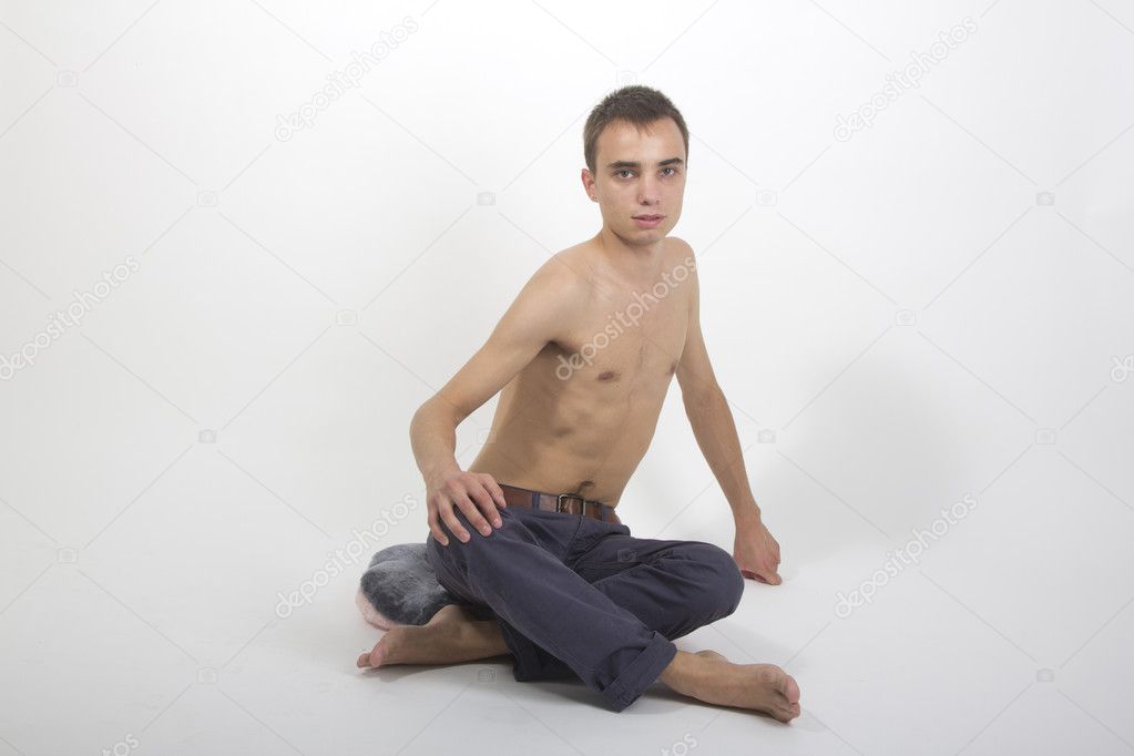 Young handsome fitness sportsman doing yoga exercises isolated