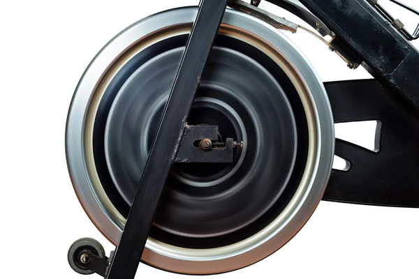 stock image Aged Spinning Bike Flywheel Rotating. Front detail.