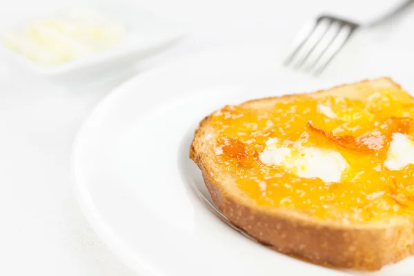 French toast close up, orange marmalade, butter, fork on white t — Stock Photo, Image