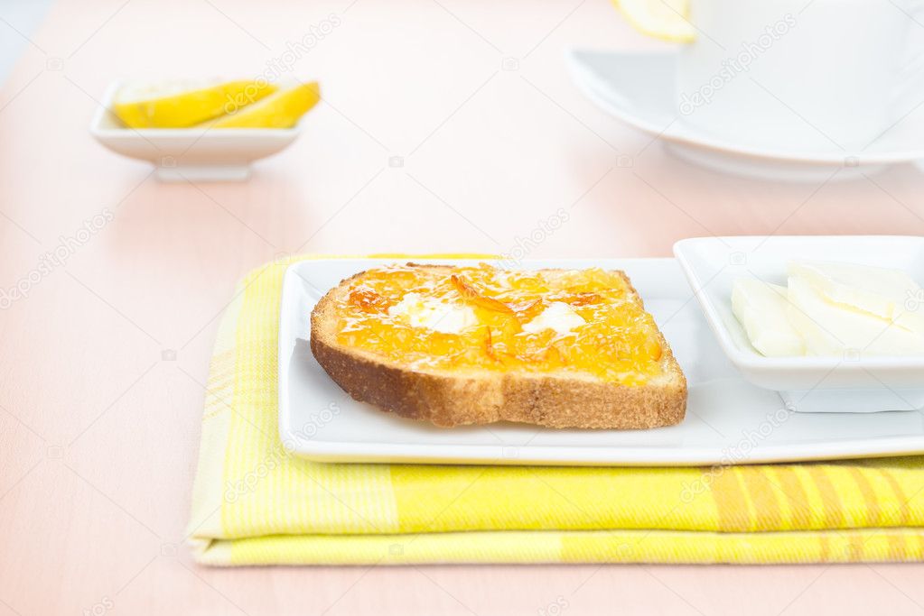 Breakfast. French toast, orange marmalade, butter, lemon and whi