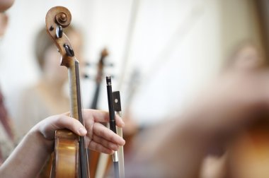 Close-up of the neck of a violin with a bow clipart