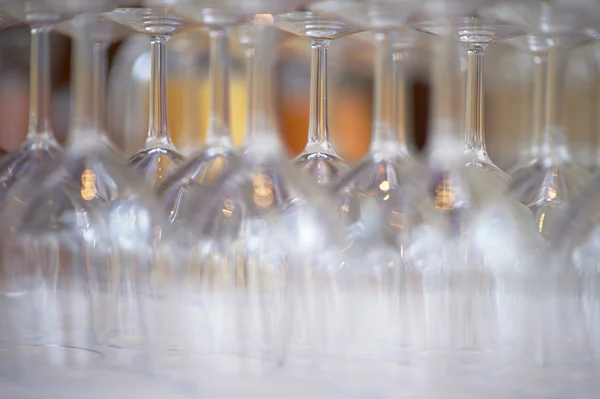 Empty wine glasses with orange juice decanters — Stock Photo, Image