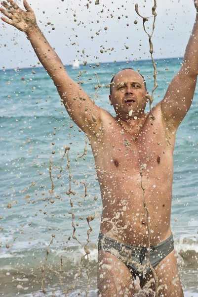 Portrait of man with spashes in the sea — Stock Photo, Image