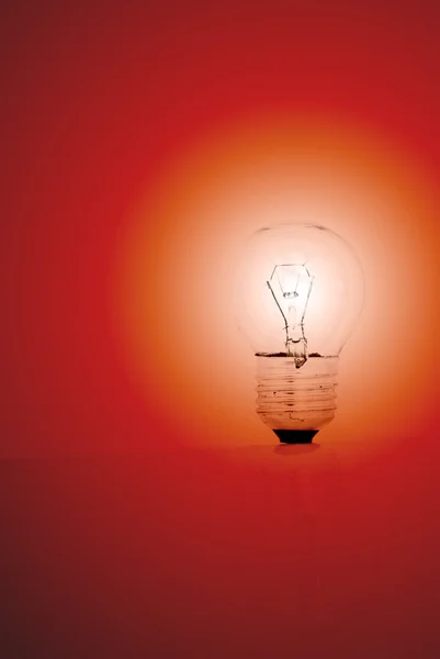 Light bulb on a red background — Stock Photo, Image