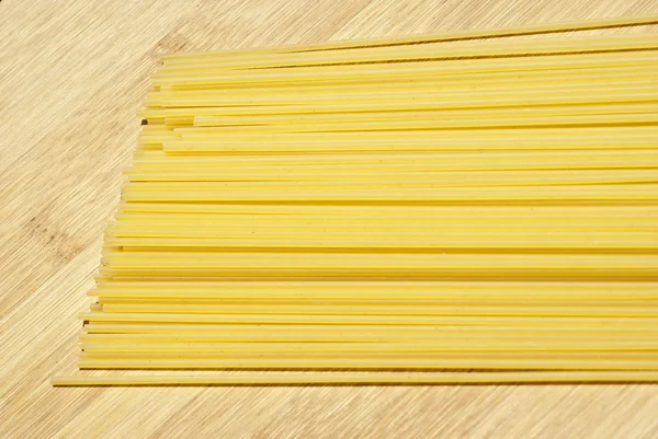 Spaghetti on wooden board — Stock Photo, Image