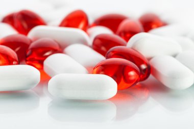 Vitamin pills: Red capsules and white tabs clipart