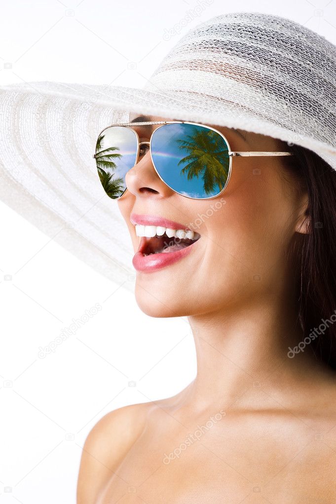 Sexy brunette with white hat and sunglasses smiling