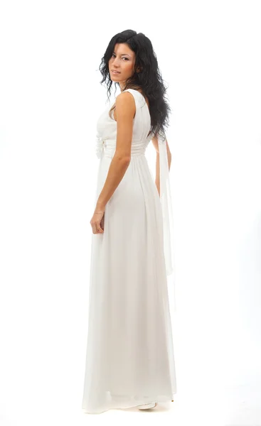 Mooi meisje in een witte jurk reputatie op witte achtergrond. — Stockfoto