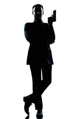 Silhouette man full length secret agent in a james bond posture clipart