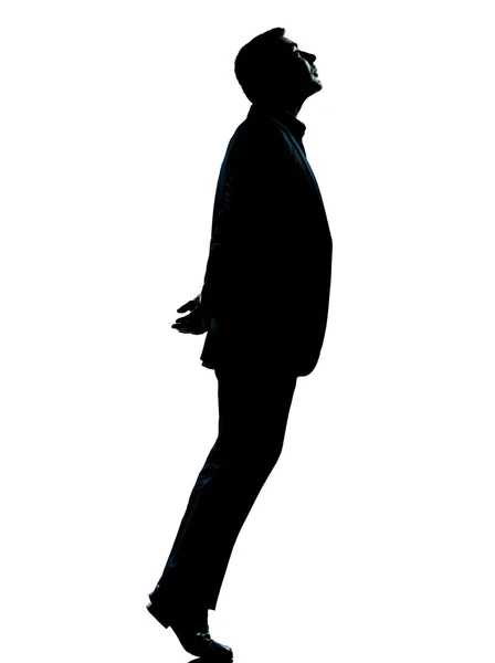 Um homem de negócios silhueta ponta dos pés olhando para cima — Fotografia de Stock