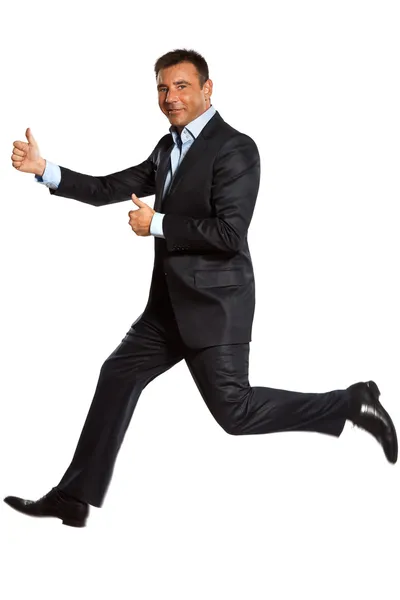 Um homem de negócios correndo pulando dois polegares para cima — Fotografia de Stock