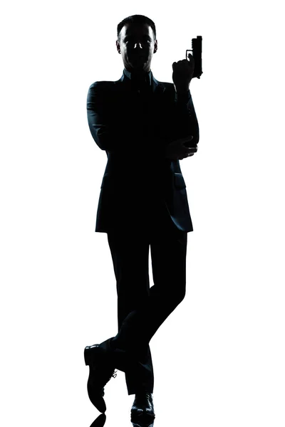 Силуэт человек полный секретный агент в Джеймс Бонд осанку — стоковое фото