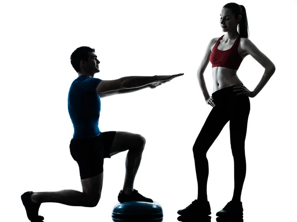 Coach man woman exercising squats on bosu — Stock Photo, Image