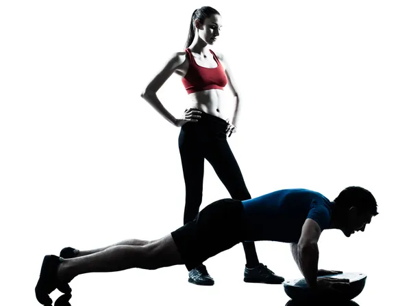 Coach man woman exercising abdominals with bosu — Stock Photo, Image